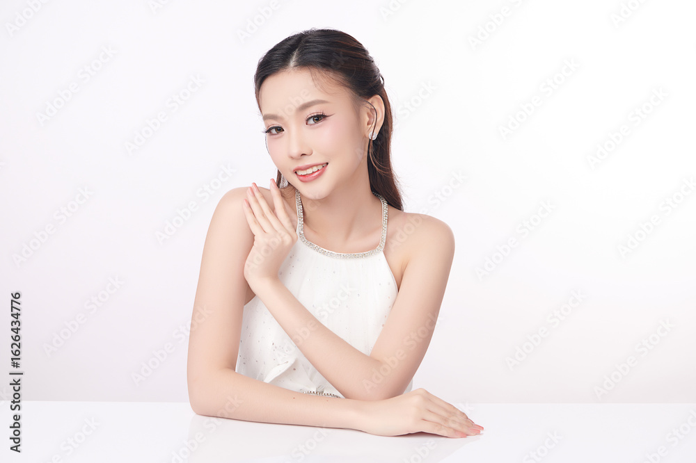 A beautiful young Asian woman with clean, fresh skin against a white background. Skincare, facial treatment, cosmetology, beauty, and spa. An elegant portrait of an Asian woman. A beautiful young Asian woman with clean, fresh skin against a white background. Skincare, facial treatment, cosmetology, beauty, and spa. An elegant portrait of an Asian woman.