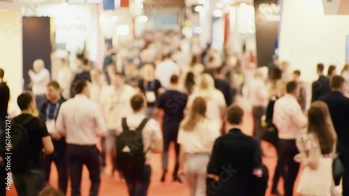 Dynamic crowd moving through bustling trade show, showcasing innovation and networking opportunities for professional business growth
