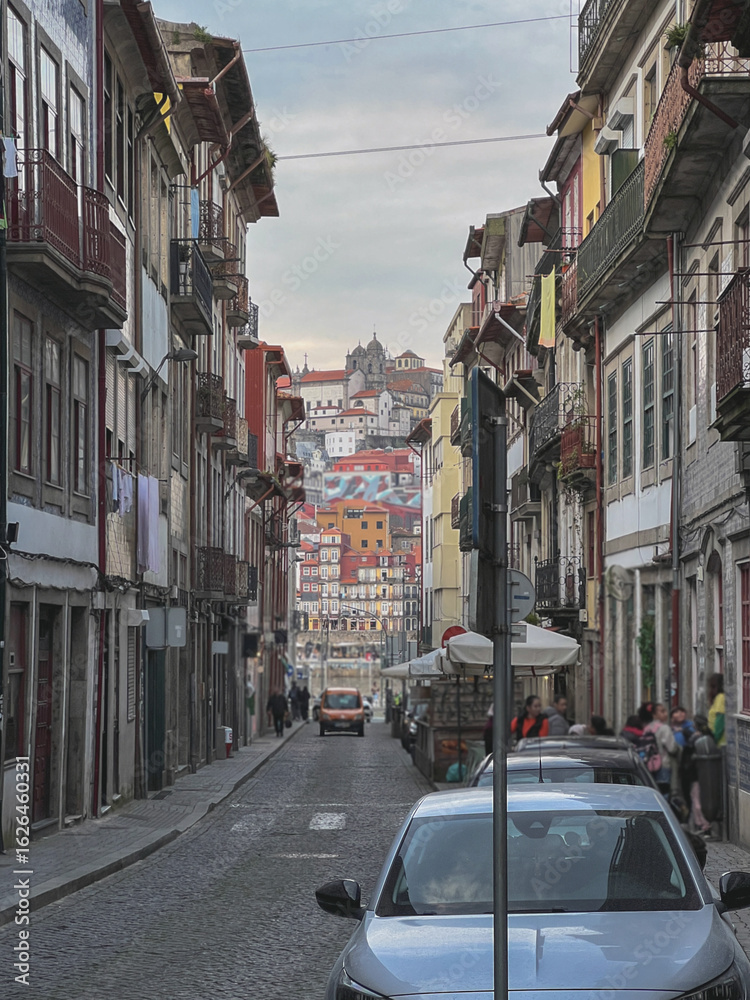 Fototapeta premium Romantic backstreet, side street or alley in historic old town of Porto Oporto, Portugal with colonial colorful tile style architecture facades, a landmark sightseeing tourist spot in old town