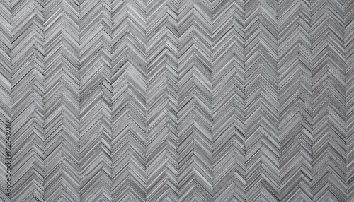 Close up of a gray herringbone pattern wood floor creating a textured zigzag design surface and background