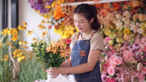Skilled Asian florist designs elegant artificial flower arrangements unique floral decor vibrant flower shop boutique selling handcrafted blooms