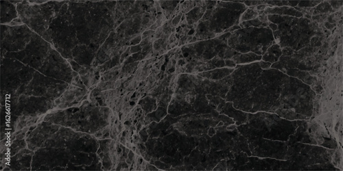 Dark and textured marble surface displaying intricate veins and natural patterns providing a sophisticated and elegant aesthetic for various design applications