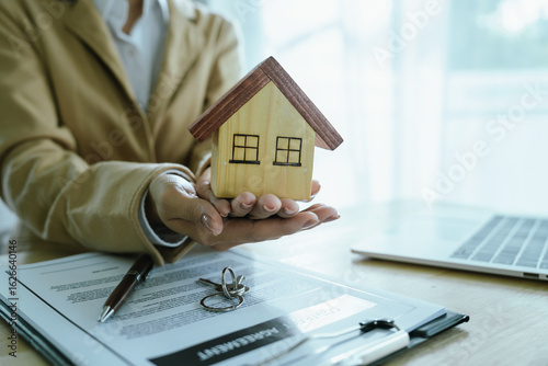 Photography The real estate sales agent will hand over the keys and sign the contract, which