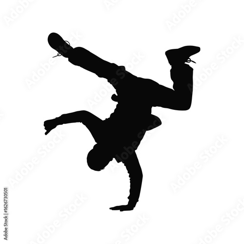 Silhouette of a breakdancer performing a dynamic handstand move