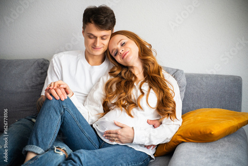 Young couple lovingly expecting their first child