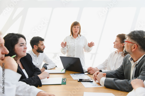 Business team meeting, leader explaining strategy to colleagues