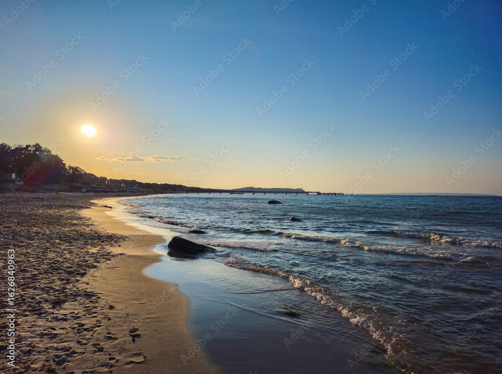 custom made wallpaper toronto digitalSunset on the beach with peaceful waves and clear sky, view along the coast near the North Perd in 18586 Göhren, island of Rügen, Germany