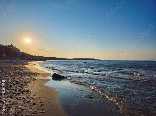 Wallpaper Mural Sunset on the beach with peaceful waves and clear sky, view along the coast near the North Perd in 18586 Göhren, island of Rügen, Germany Torontodigital.ca
