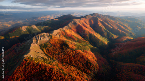 Aerial view of a mountain range covered in autumn foliage