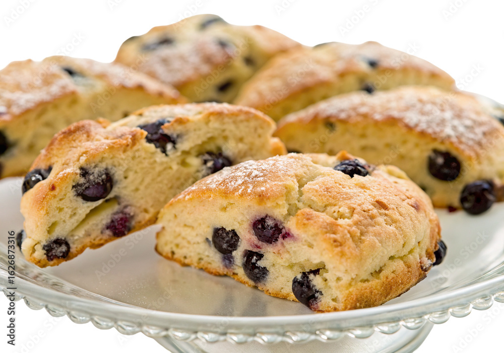 Freshly baked blueberry scones on plate with sugar topping displayed in close up with golden crust Freshly baked blueberry scones on plate with sugar topping displayed in close up with golden crust