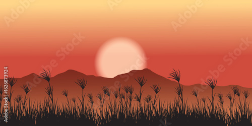 Sunset over a mountainous landscape with silhouettes of plants in the foreground. The sun is orange-pink in color and the sky is yellow-red. The mountains are brownish-red in color.