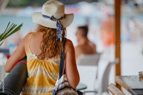 Unrecognizable young woman in light dress with yoga mat in hat and canvas bag
