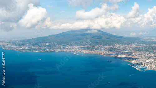 Aerial view from Mount Faito overlooking Mount Vesuvius, the city of Naples, and the coastal area including Castellammare port, Torre Annunziata, and Torre del Greco, Italy.