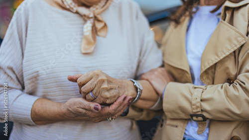 Foto Elderly Woman Holding Hands With Caregiver in a Warm Embrace