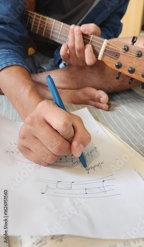 Writing Music Notes with Guitar in Hand