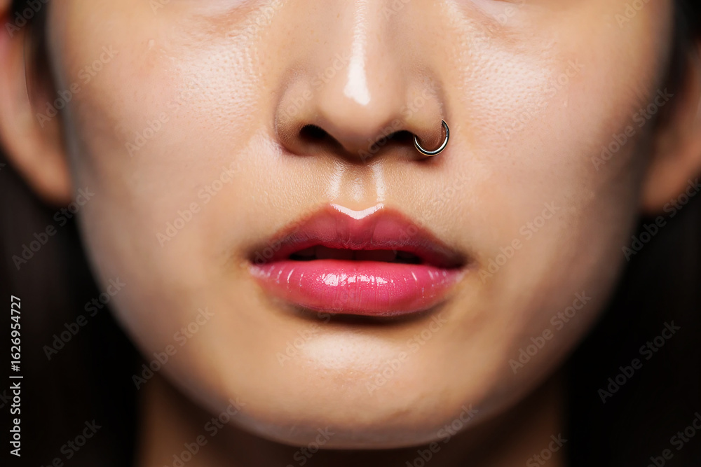 Obraz premium Shiny pink lips and nose ring glossy mouth