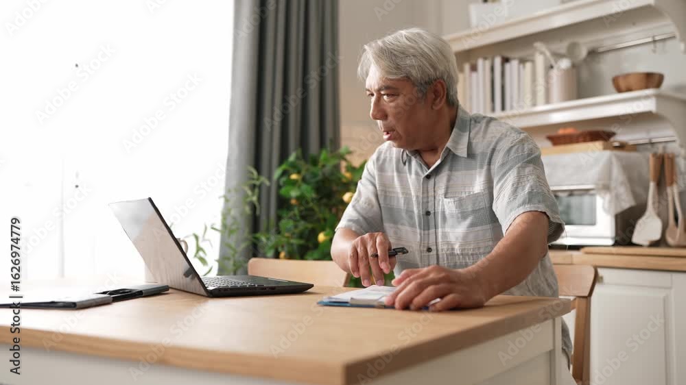Senior business man with casual cloth looking at financial chart at home while working on laptop and making decision. Manager sitting at home while writing at document and planning strategy. Myrmidon. Senior business man with casual cloth looking at financial chart at home while working on laptop and making decision. Manager sitting at home while writing at document and planning strategy. Myrmidon.