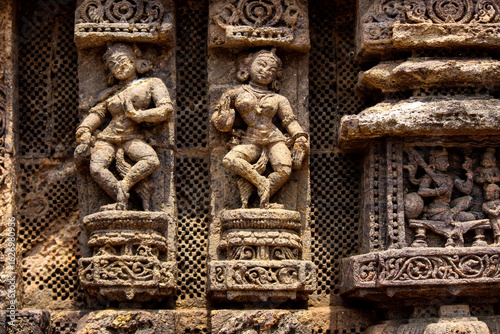A close-up view of detailed stone carvings on the wall of Konark sun temple, an ancient temple.