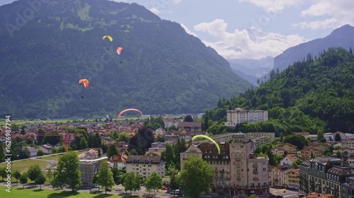 Paragliders Soaring Above Interlaken, Switzerland with Alpine Mountains in the Background