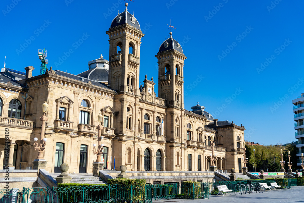 Obraz premium The City Hall of San Sebastian stands proudly under the clear blue sky on a sunny day in Spain. Spain, 2024-11-01