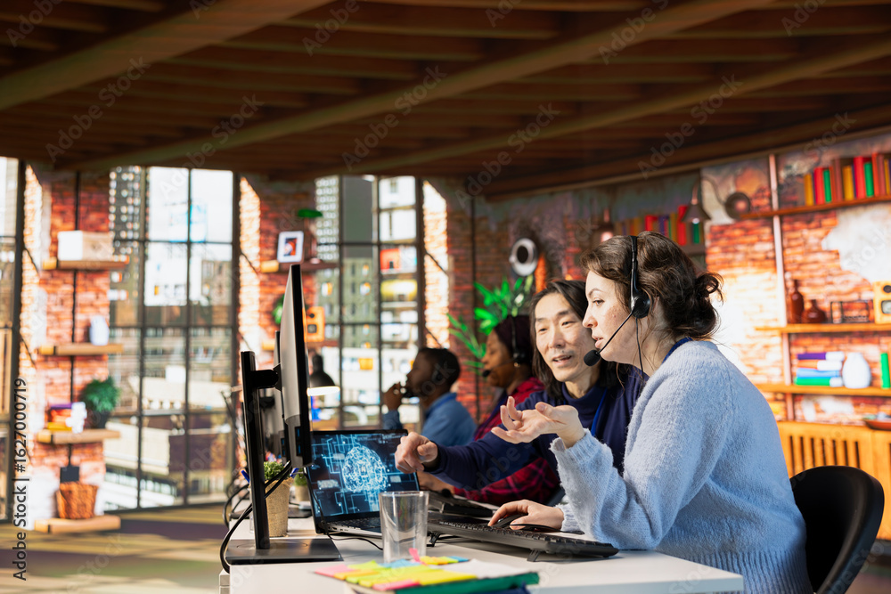 Naklejka premium Experienced call center manager guiding intern on how to use AI chatbot in office. Asian customer support workplace onboarding specialist teaching new worker to use artificial intelligence assistant