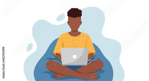 A young Black man comfortably works on his laptop while sitting cross-legged on a blue bean bag chair, illustrating remote productivity and digital lifestyle.