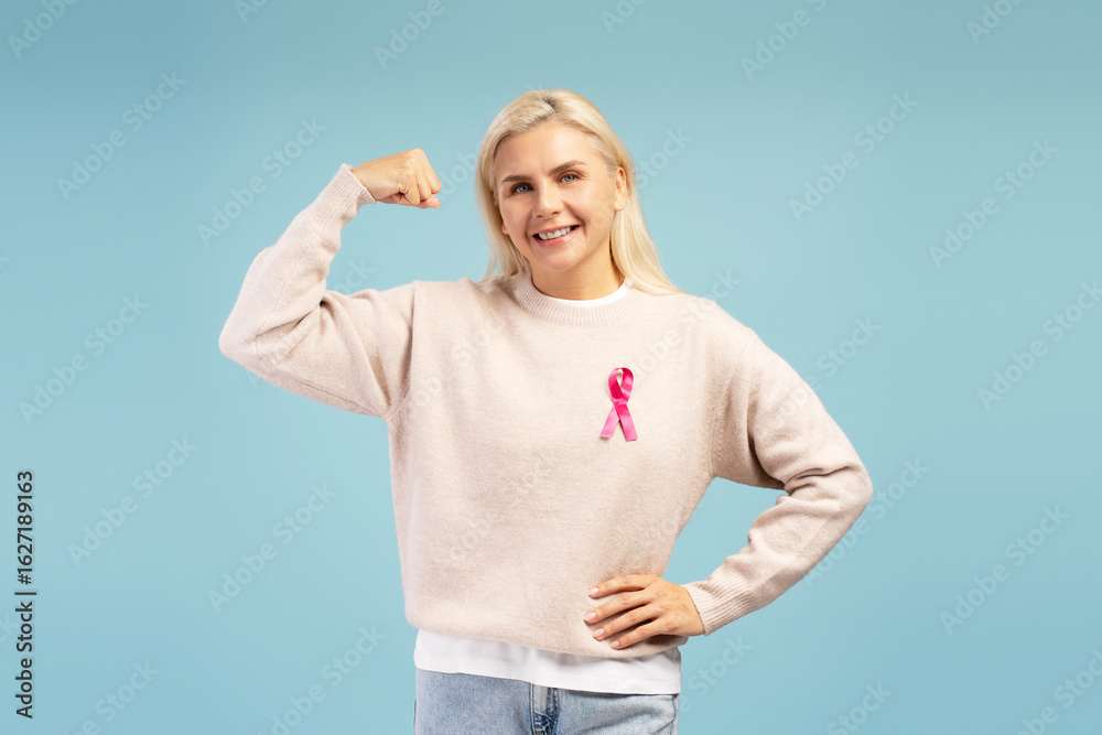 Fototapeta premium Woman showing strength and support for breast cancer awareness