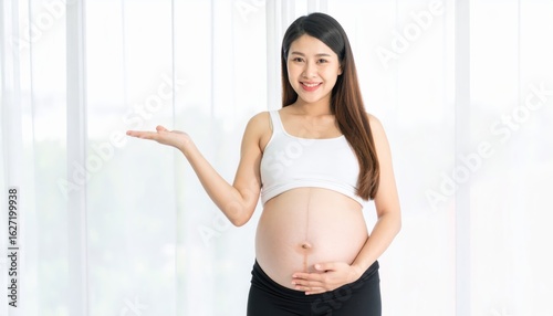 Free Download A pregnant woman embraces her belly in serene, sunlit room, portrait of motherhood - GFXLoad