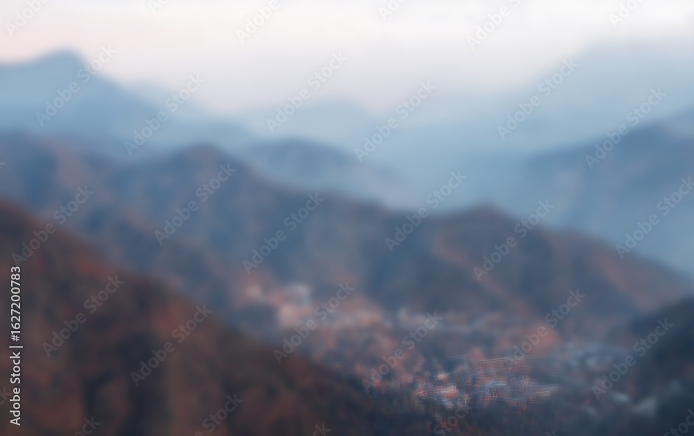 Fototapeta premium Blurry mountains and valley at dusk