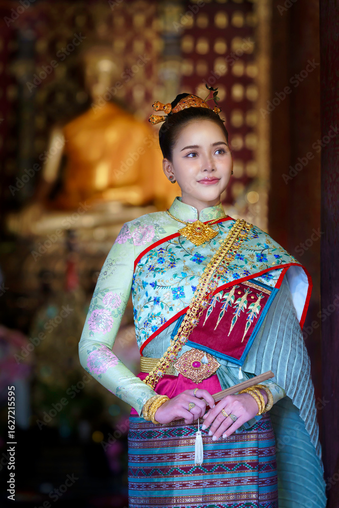 Fototapeta premium Pretty Asian Thai woman wearing traditional Thai dress costumes according to Thai culture at the ancient temple in famous tourist attraction in Thailand.