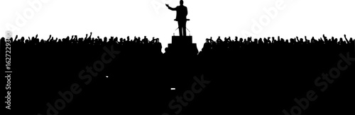 leader speaking to crowd from podium silhouette
