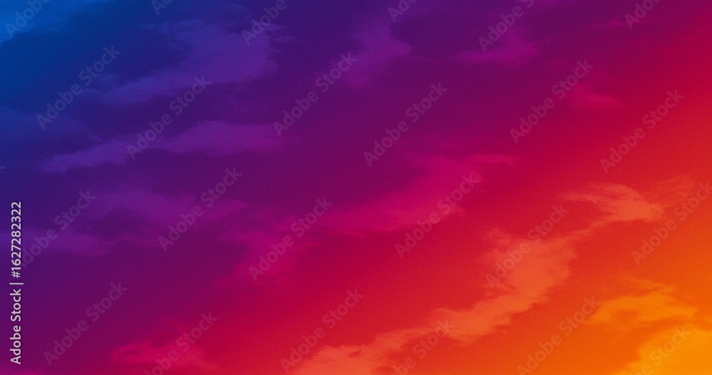 Obraz premium Vibrant gradient sky with clouds transitioning from deep blue to fiery orange, perfect for abstract backgrounds and modern designs
