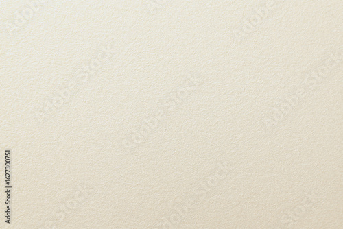 Close up view of ivory textured paper with subtle surface details
