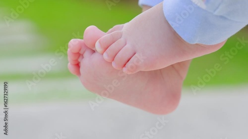 The foot movement of a 10-month-old baby, with smooth skin, shows the child's innocence.