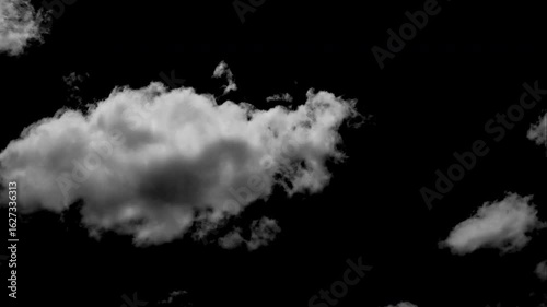 Time-lapse of separate white clouds on a black background shows real clouds.