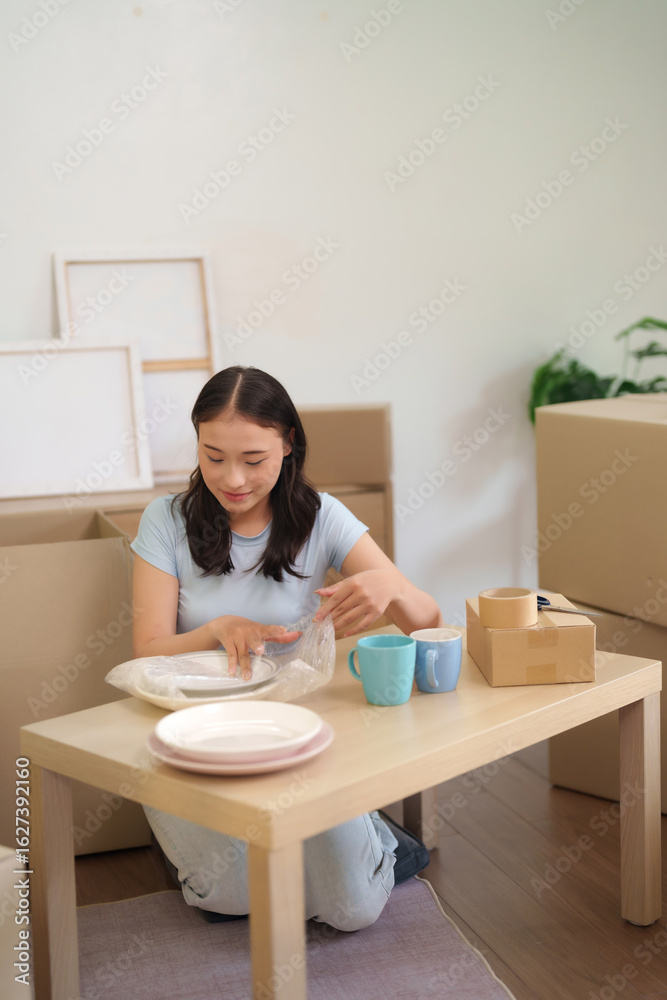 Asian Woman Packing Dishes Preparing Move Residential Apartment Relocation Organizing Home Items Securely New Living Space Journey Asian Woman Packing Dishes Preparing Move Residential Apartment Relocation Organizing Home Items Securely New Living Space Journey