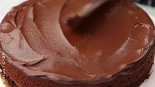 Decadent Chocolate Cake Being Frosted with Rich, Smooth Ganache Icing, Perfect for Sweet Celebrations and Homemade Dessert Recipes