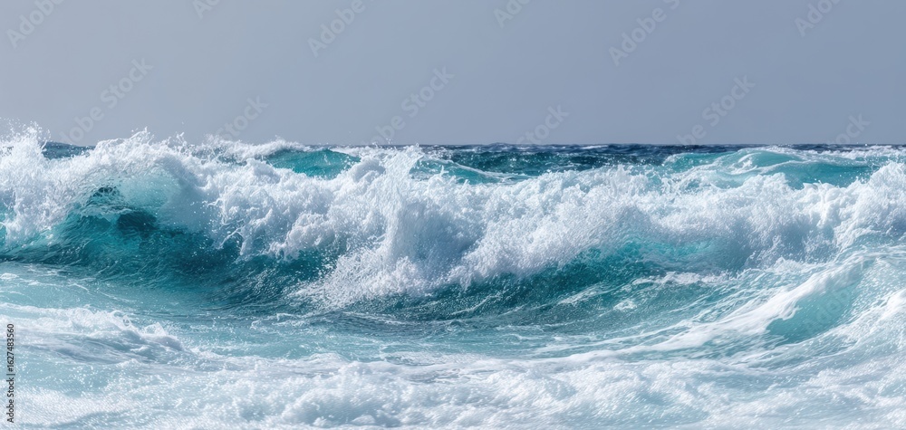 Fototapeta premium The Majestic Ocean Waves Dancing Under the Clear Blue Sky