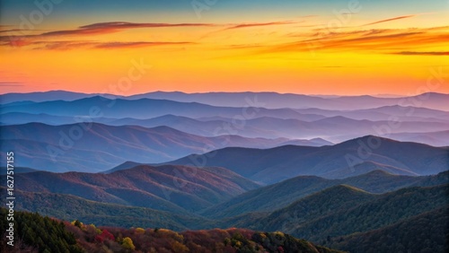 Fototapeta Naklejka Na Ścianę i Meble -  Vibrant sunset over layered mountain ranges