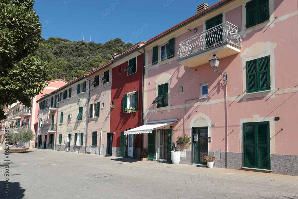 Naklejka premium Old street in Italian countryside near sea. Traditional building. Sun day. Entrance, window to house. Nature and sky.