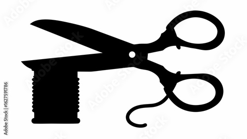 Silhouette of open scissors cutting a spool of thread with handles and blades in a black and white image
