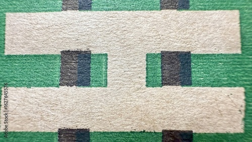 Photos macro close up of vintage printed circuit board showing textured green substrate