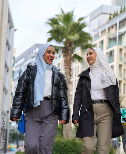 Muslim women walking and talking in the city