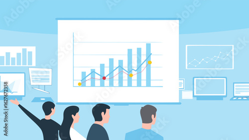 Presentation of a growth chart to a group of people in a light blue office with computers and monitors