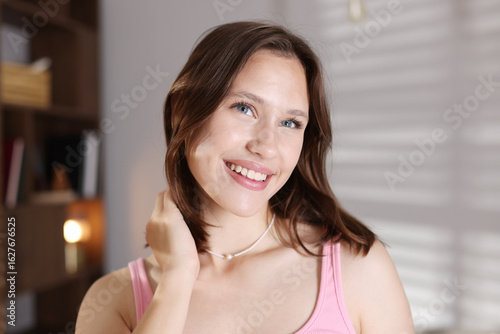 Portrait of smiling teenage girl at home Free Download Portrait of smiling teenage girl at home - GFXLoad