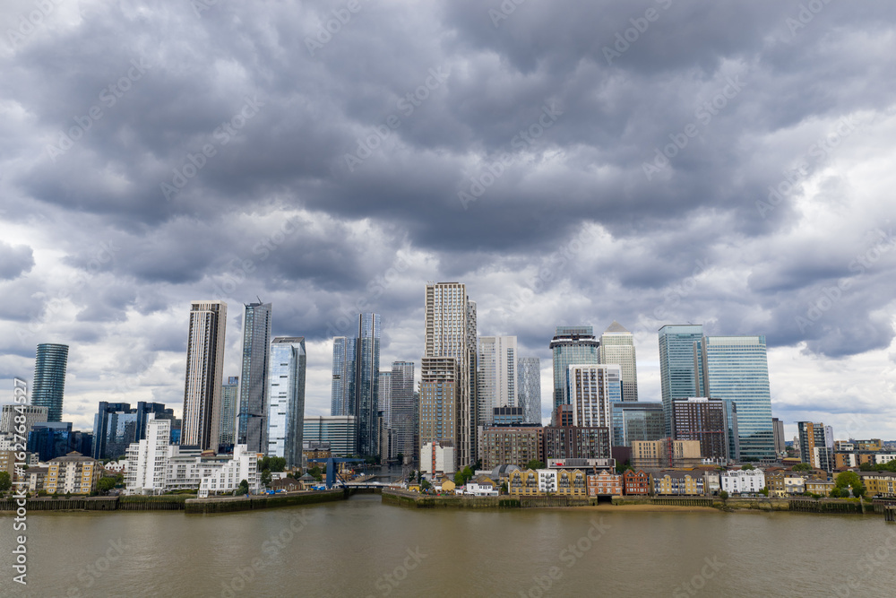 Fototapeta premium Drone image of Canary Wharf Skyline under a stormy sky from across the Thames.