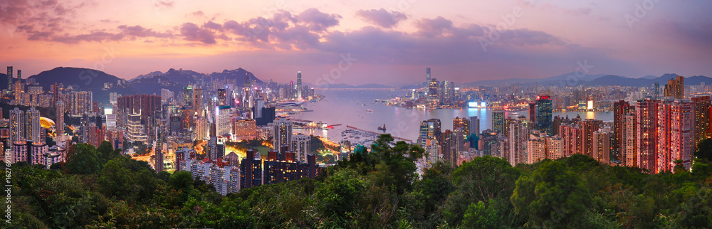 Obraz premium Hong Kong cityscape with skyscrapers at sunset, panorama