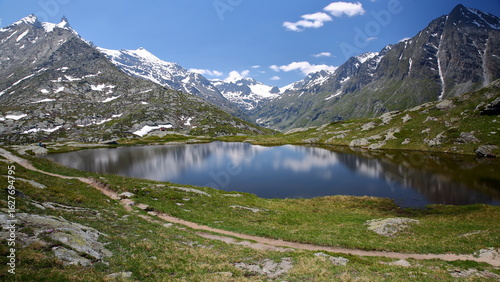 Reflections on lac Perrin superieur (Perrin upper lake) located above Petit Mont Cenis Pass (near Mont Cenis lake), Maurienne Valley, Savoie, Northern French Alps, France, surrounded by mountains