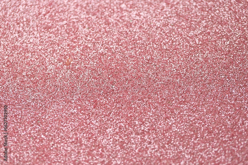 Fototapeta premium Beautiful pink glitter sparks texture as background with shallow depth of field
