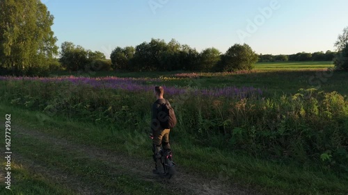 Man is riding a electric unicycle euc on a country road. People Ecological Electric Transportation Vehicle Monowheel